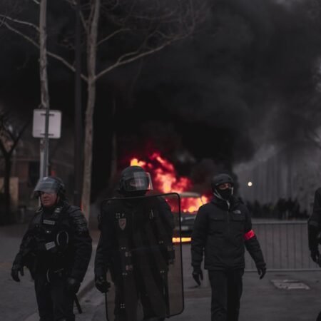three firemen standing near trees